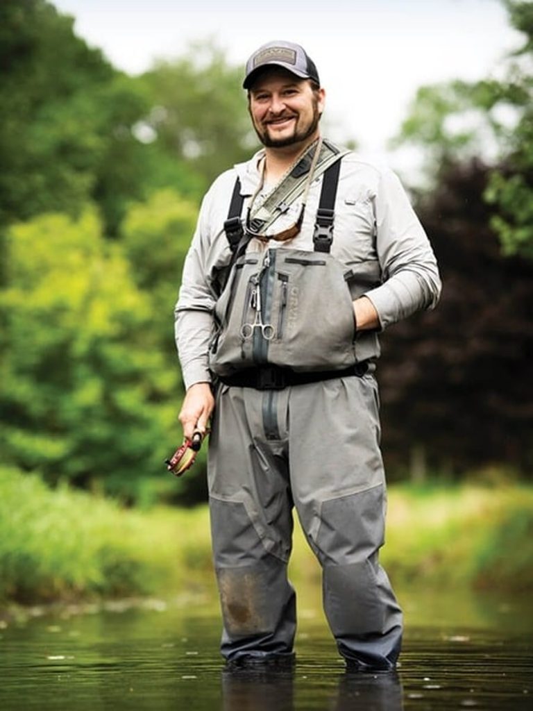 Orvis guide of the year, Dustin Coffy standing in a Appalation stream.